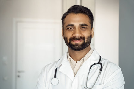 Closeup portrait of confident young male doctor therapist in white medical robe