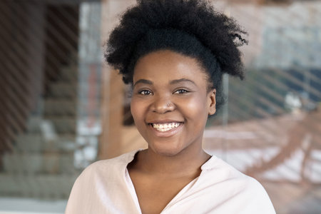 Young african amercian woman smiles looking at camera closeup portrait