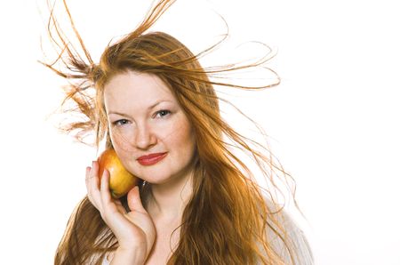 The beautiful girl with an apple on a white backgroundの写真素材