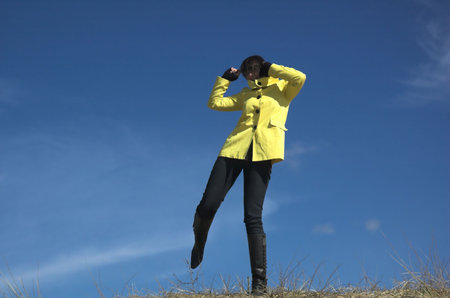 The girl dances on a background of the skyの写真素材