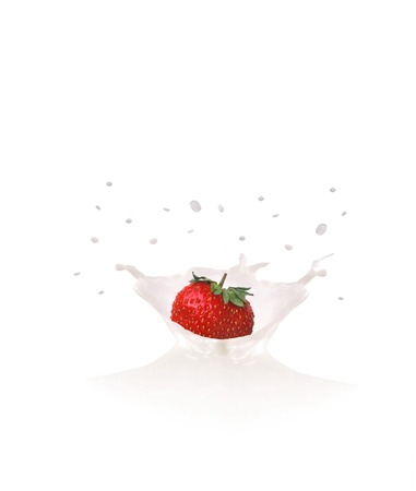 Strawberry falls into milk causing splash and dropsの写真素材