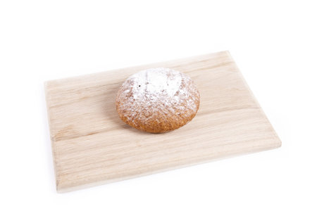 The fresh bun isolated on wooden plateの写真素材