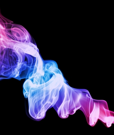 A swirled spiral of colored smoke on a black backgroundの写真素材