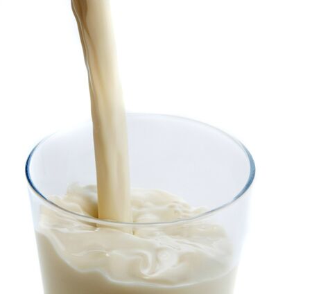 pouring milk into a glass  splashes of milkの写真素材