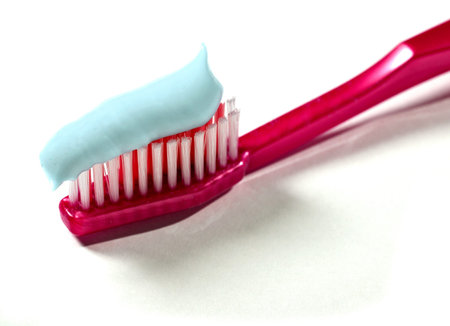 A toothbrush with toothpaste on a white background 