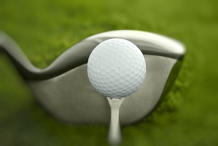 Golf club and ball in grassの写真素材