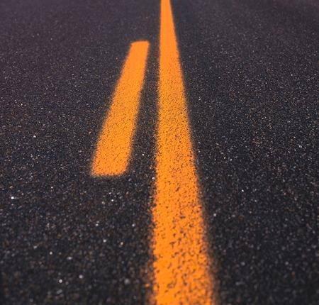 Asphalt road texture with yellow stripeの写真素材
