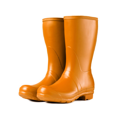 Yellow rubber boots isolated on whiteの写真素材