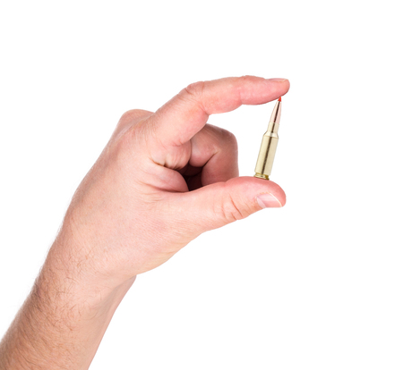 hand holding bullet isolated on white backgroundの写真素材