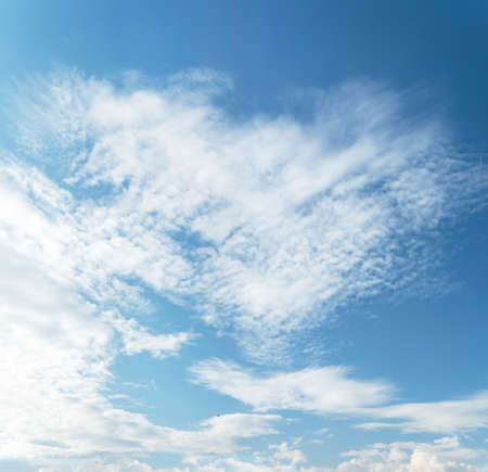Blue and cyan gradient colored sky and white clouds floating on air. Astonishing view of harmony of cumulus and clear sky.の写真素材
