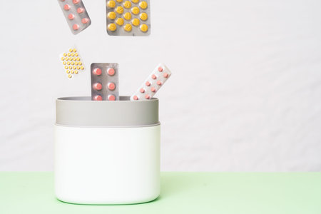 Full of expired pills and medicines in the trash bin with recycling symbol. Waste pills collected to be recycled. waste management concept.の写真素材