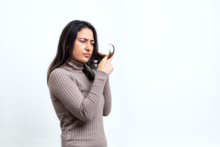 Close up photo of young woman with serious hair problems. Hair loss and care concept.の写真素材