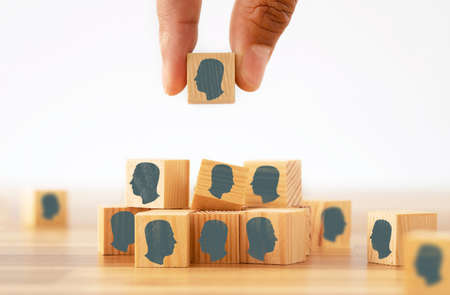 Close up photo of hand selecting one of the interviewers on job application. Concept of employee hire and recruitment.の写真素材