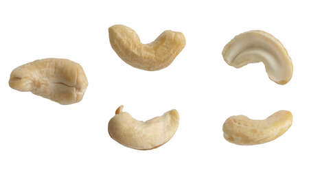 Macro photo of floating raw cashews on isolated white background.の写真素材