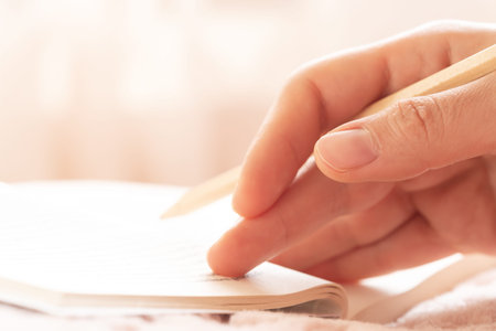 Woman holding wooden pencil and reading book. Concept of hardwork, study, book lover.の写真素材