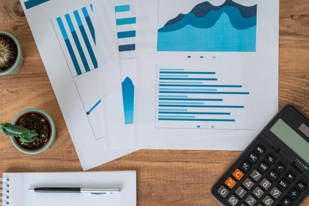 Top view photo of business workers desktop with graphics and statistics. Finance and business accounting concept.の写真素材