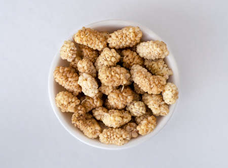 Close up photo of dried raw mulberry on isolated background.の写真素材