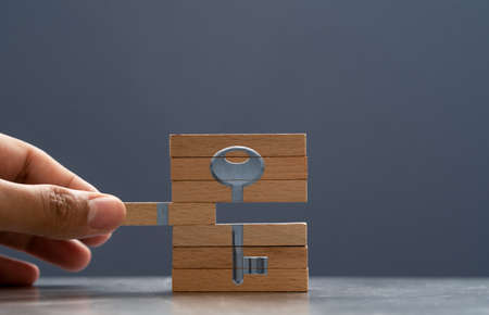 Hand putting wooden blocks together. Concept of finding solution.の写真素材