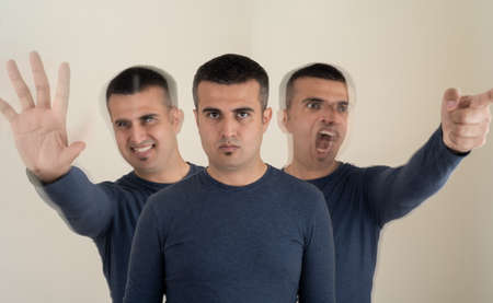 Portrait of a man with tree different emotional face expressions as a symbol of instat personality shifts. Concept of bipolar and borderline.の写真素材