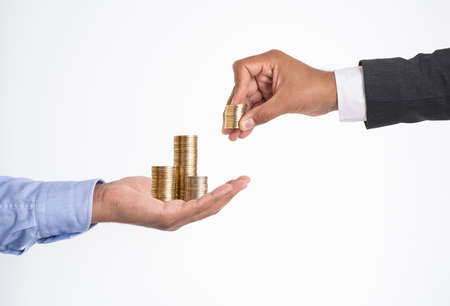 Close up photo of stacked coins on isolated background. Concept of investing money and making profits on new startup.の写真素材