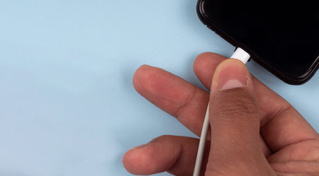 Close up photo of a hand charging mobile phone