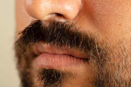 Close up photo of brown skinned man with long facial hair and mustacheの写真素材