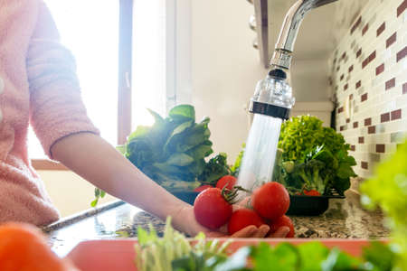 woman hands washing vegetables in the sink. Clean and hygiene at home.の写真素材