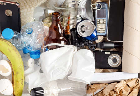 Electronic waste materials laid on green isolated background. waste management conceptの写真素材