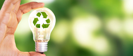 Close up photo of lightbulb with recycle icon with nature background as a symbol of reduce, reuse and recycle of resources. Concept of protect nature, environment, ecosystem.の写真素材