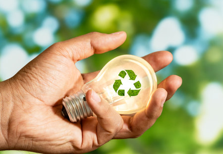 Close up photo of lightbulb with recycle icon with nature background as a symbol of reduce, reuse and recycle of resources. Concept of protect nature, environment, ecosystem.の写真素材
