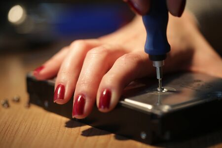 Woman technician work on a hard driveの写真素材
