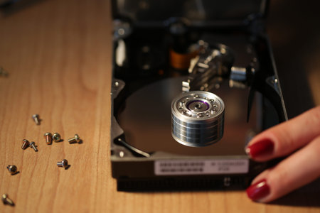 Woman technician work on a hard drive