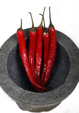 Granite mortar and pestle with red chilliesの写真素材