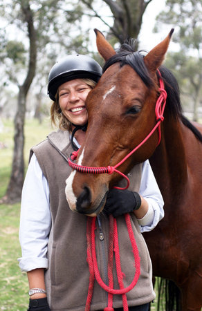 Female rider and horse in the Australian outbackの写真素材