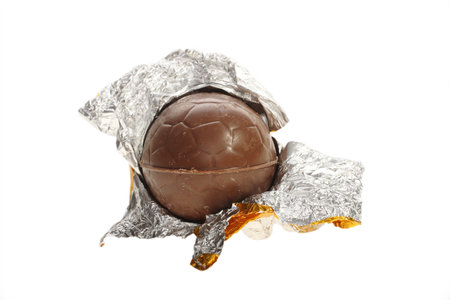 Easter chocolate egg, opened in gold foilの写真素材