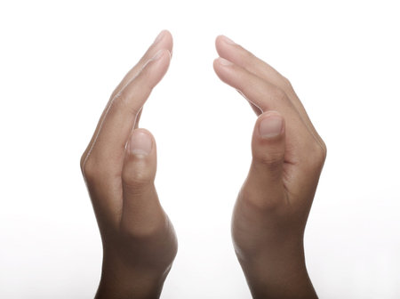 Two hands open in prayer against white backgroundの写真素材