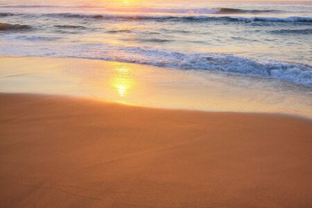Serene wave background image, against a sunriseの写真素材
