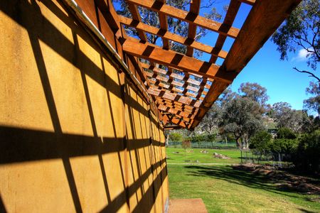 Bonsai greenhouse with wooden lattice against blue skyの写真素材