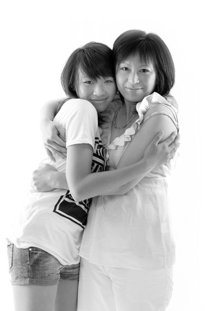 mum and daughter having fun, isolated on white backgroundの写真素材