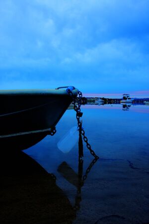 boat lying on the side at low tideの写真素材