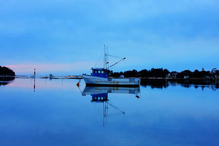 boat lying on the side at low tideの写真素材
