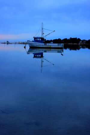 boat lying on the side at low tideの写真素材