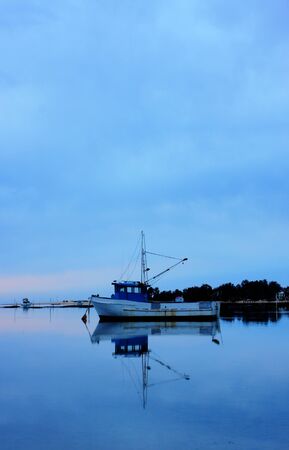 boat lying on the side at low tideの写真素材