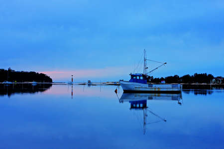 boat lying on the side at low tideの写真素材