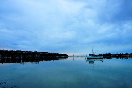 boat lying on the side at low tideの写真素材