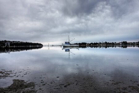 boat lying on the side at low tideの写真素材