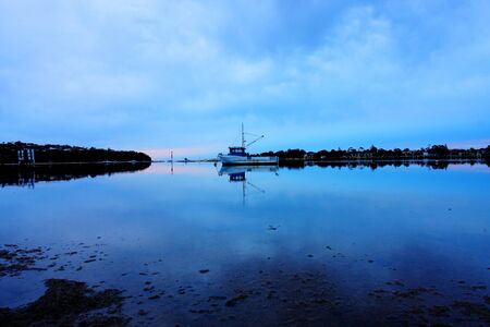 boat lying on the side at low tideの写真素材
