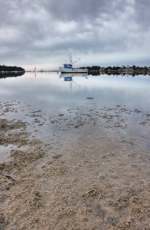 boat lying on the side at low tideの写真素材
