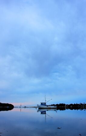 boat lying on the side at low tideの写真素材