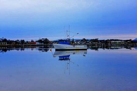 boat lying on the side at low tideの写真素材